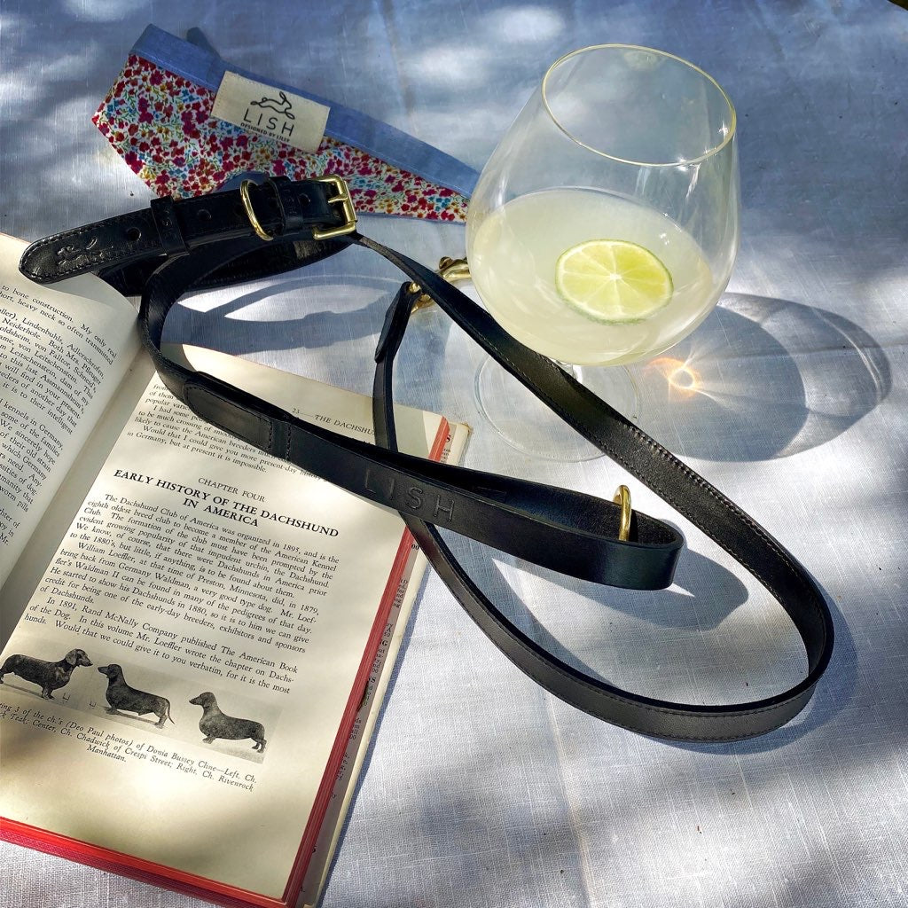 LUXURY BLACK DESIGNER DOG LEAD AND DOG LEASH MADE IN ENGLAND BY LISH ON SUMMER TABLE WITH GIN AND TONIC IN THE ENGLISH ECCENTRIC GARDEN