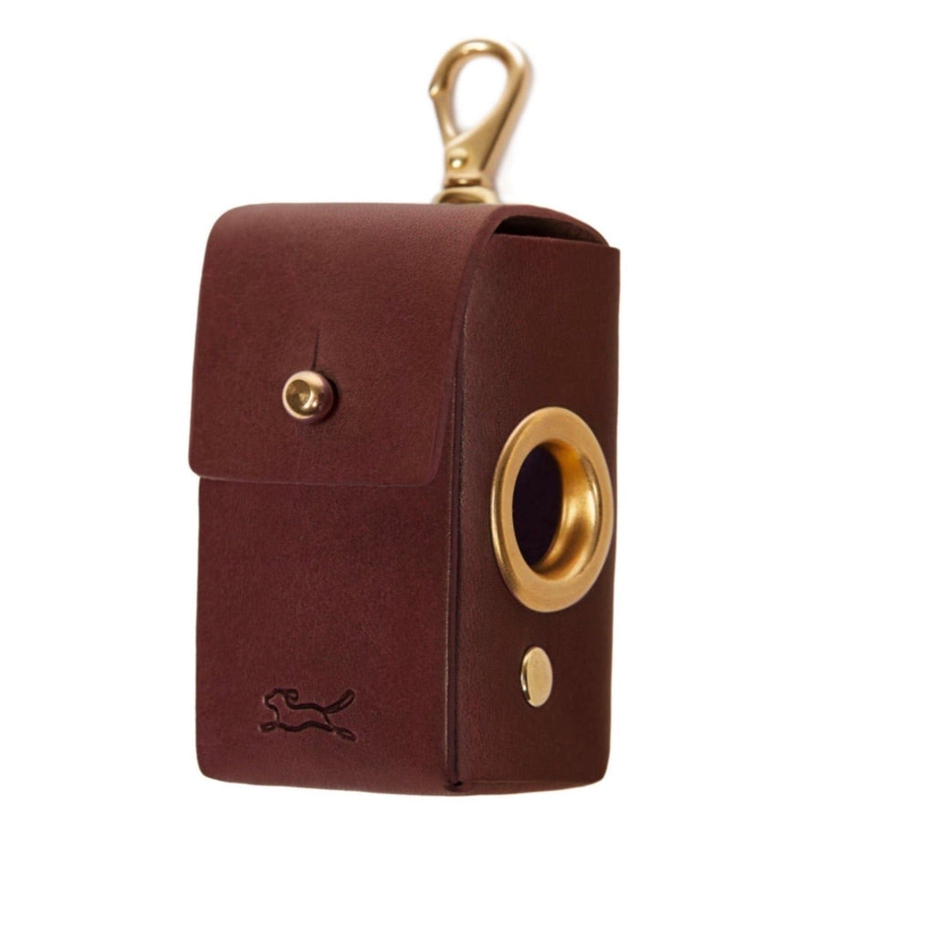 Made from eco vegetable tanned leather in the Tuscan hills that uses no toxic chemicals. The Italian leather is handcrafted by British saddlers and hallmarked with the luxury LISH stamp. Coopers Eco Leather Toffee Brown Poop Bag Dispenser luxury designer bag at angle with gold hardware