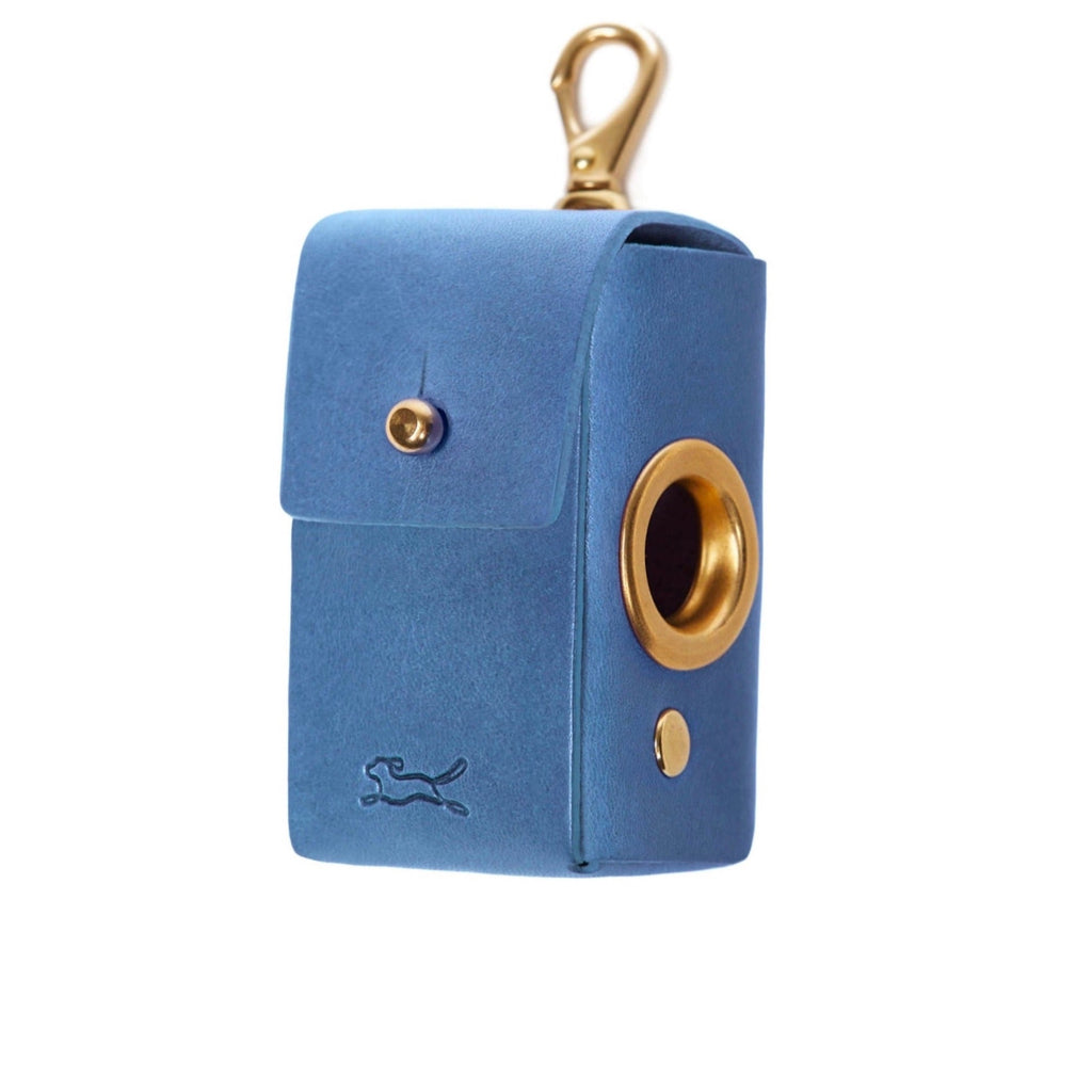 Made from eco vegetable tanned leather in the Tuscan hills that uses no toxic chemicals. The Italian leather is handcrafted by British saddlers and hallmarked with the luxury LISH stamp. Coopers Eco Leather Cobalt Blue Poop Bag Dispenser luxury designer bag at angle with gold hardware