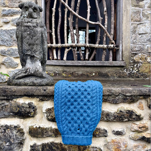 Blue real wool Aran luxury dog jumper, hand knitted on a balcony cottage wall made by LISH Luxury designer pet apparel and lifestyle brand 