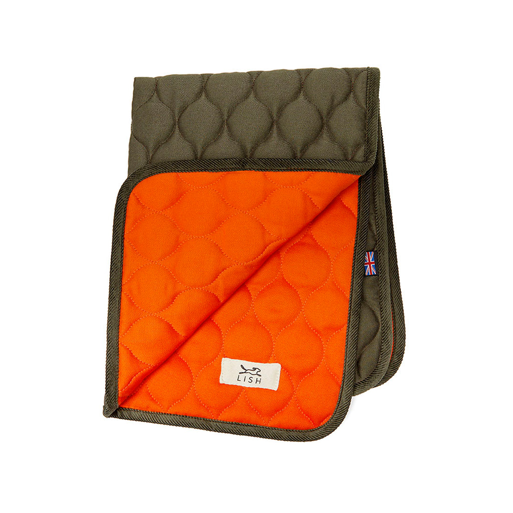 The Winkley Orange Cotton Designer Pet Travel Blanket, is made with eco friendly cotton and handcrafted in England. Double layered reversible luxury dog blanket quilted using recycled fibres and is reversible open folded
